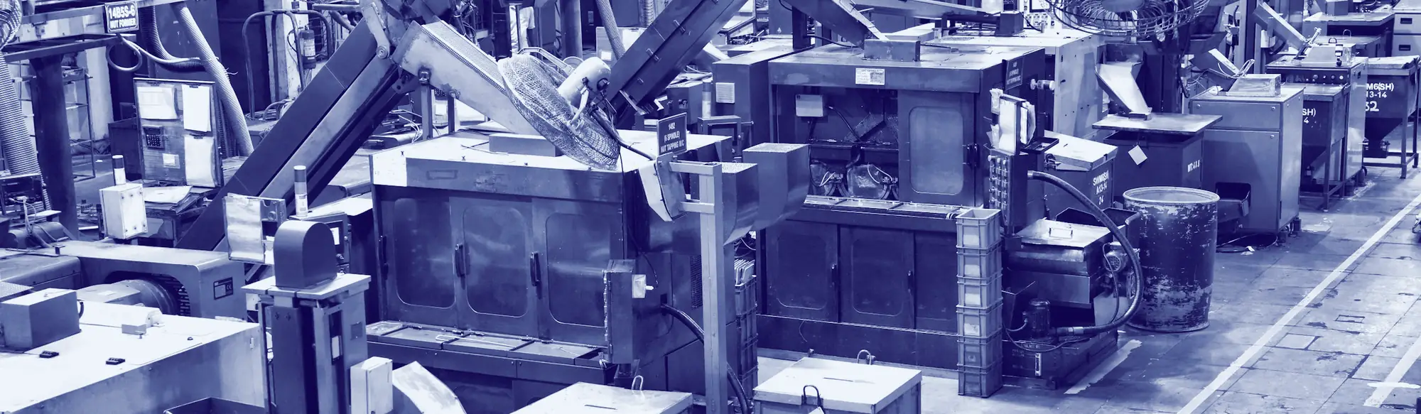 An Indian factory floor: rows of machines, parts bins and yellow floor lines